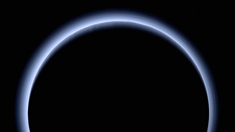 This image made available by NASA in March 2017 shows Pluto illuminated from behind by the sun as the New Horizons spacecraft travels away from it at a distance of about 120,000 miles. (NASA/Johns Hopkins University Applied Physics Laboratory/Southwest Research Institute via AP)