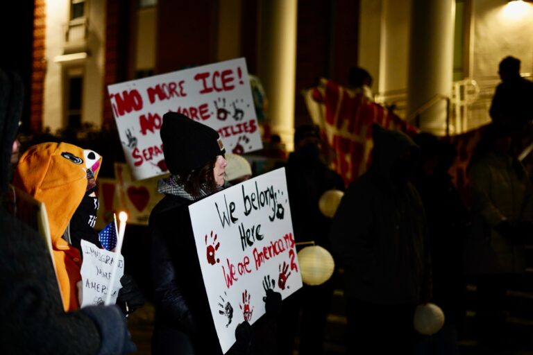 Advocates and community members hold a vigil outside of Norristown Municipal Hall condemning ICE's actions in Montgomery County. (Kenny Cooper/WHYY).