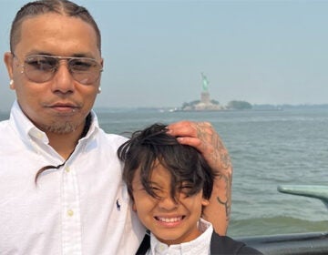 Parady La, a man who died in U.S. Immigration and Customs Enforcement custody, holds the head of a child in a photo