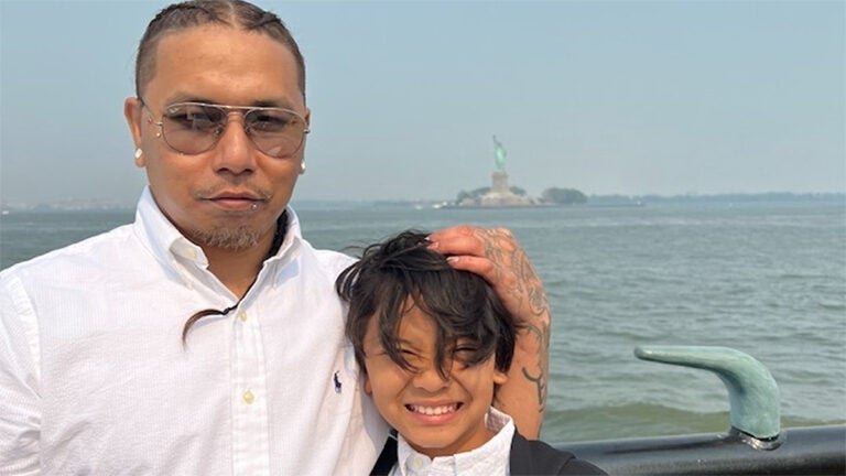 Parady La, a man who died in U.S. Immigration and Customs Enforcement custody, holds the head of a child in a photo