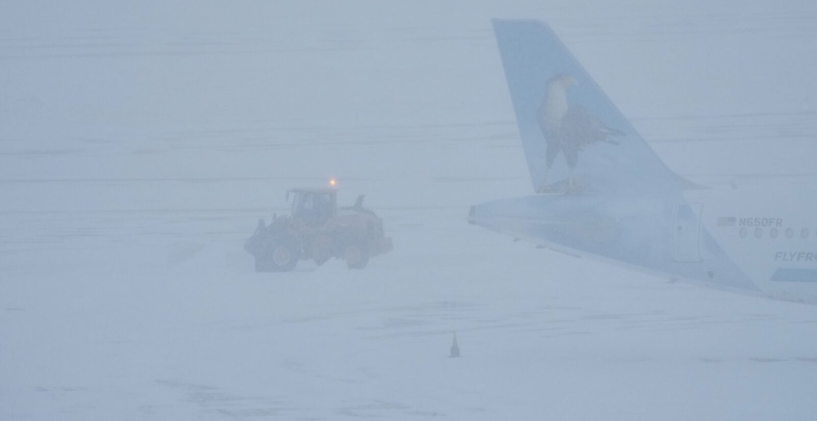 Airport crew plow snow during a winter storm in Philadelphia, Sunday, Jan. 25, 2026.