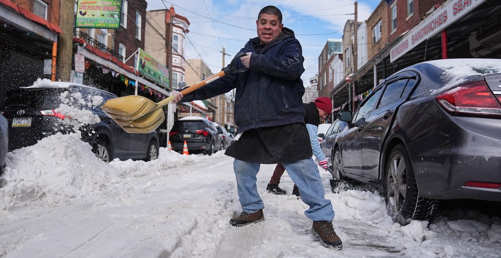 Gilberto Hernandez shovels snow in the aftermath of a winter storm in Philadelphia, Monday, Jan. 26, 2026.