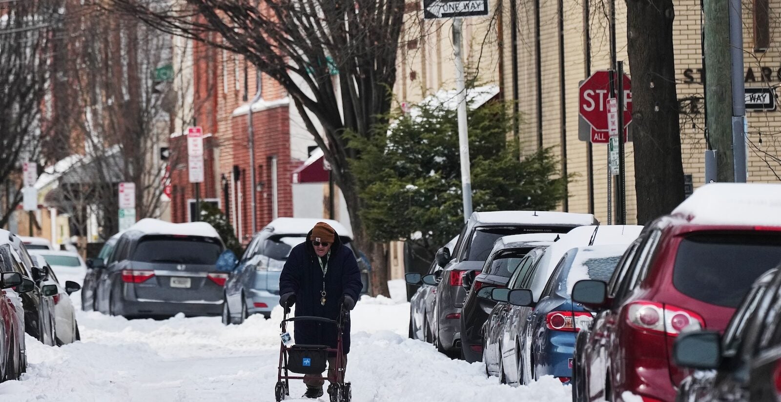 A person walks on a snow covered street in the aftermath of winter storm in Philadelphia, Monday, Jan. 26, 2026.