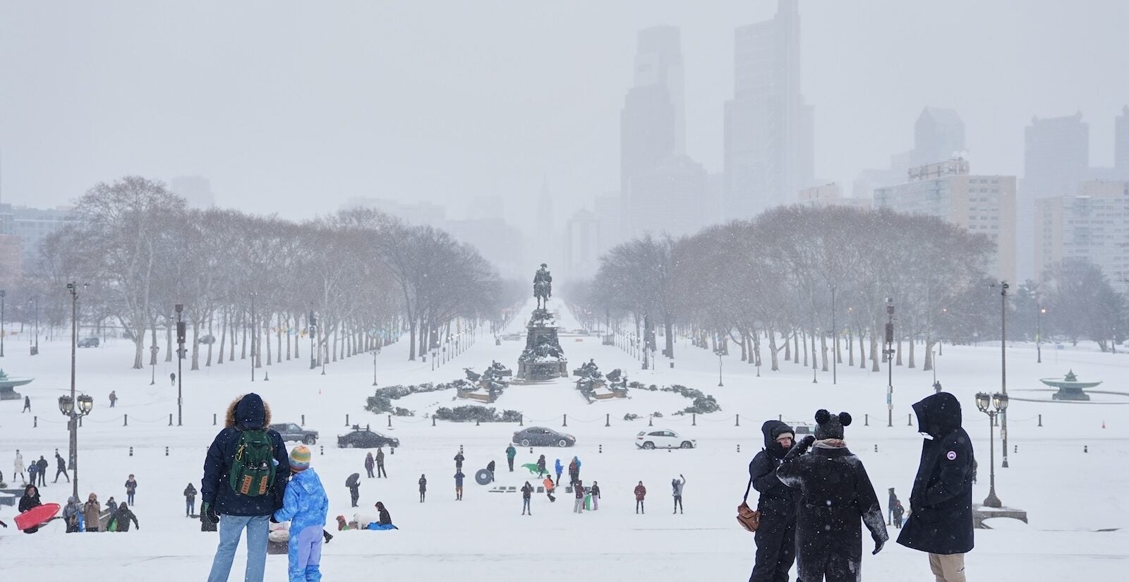 People gather at Philadelphia Art Museum steps during a winter storm in Philadelphia, Sunday, Jan. 25, 2026.