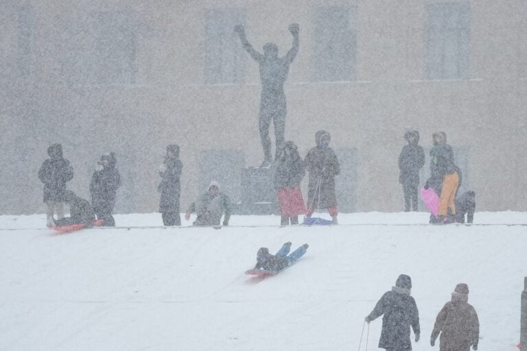 People sled on Philadelphia Art Museum steps by the Rocky statue during a winter storm in Philadelphia, Sunday, Jan. 25, 2026.