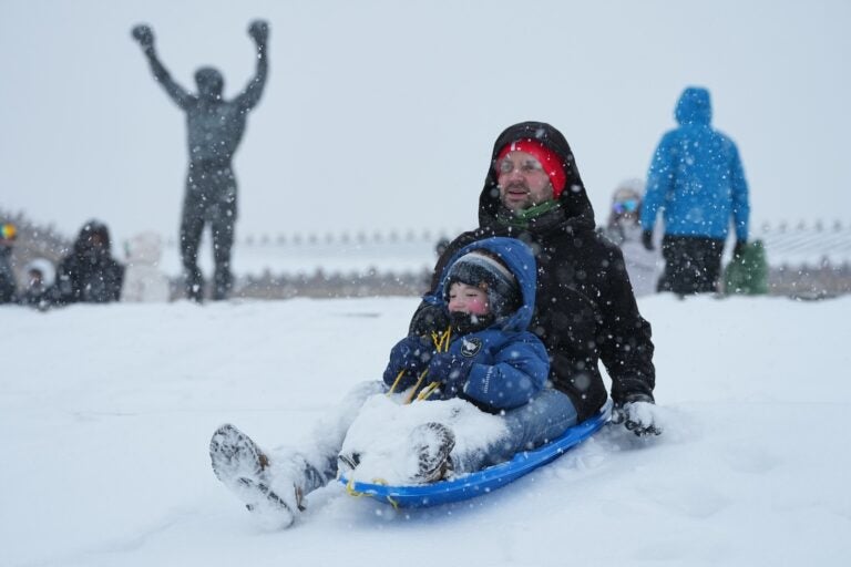 People sled on Philadelphia Art Museum steps by the Rocky statue during a winter storm in Philadelphia, Sunday, Jan. 25, 2026.