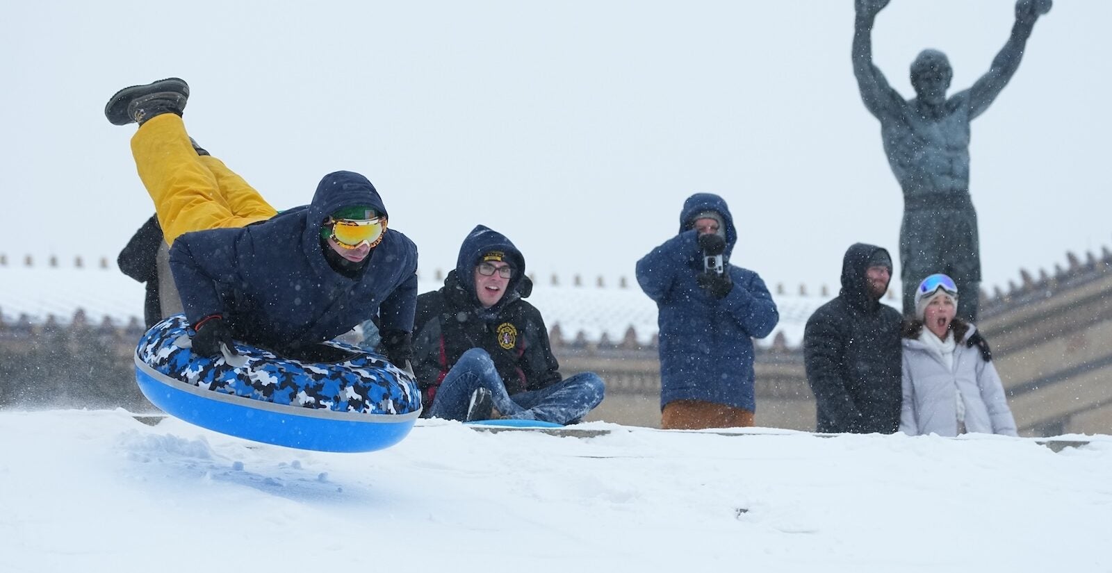 People sled on Philadelphia Art Museum steps by the Rocky statue during a winter storm in Philadelphia, Sunday, Jan. 25, 2026.