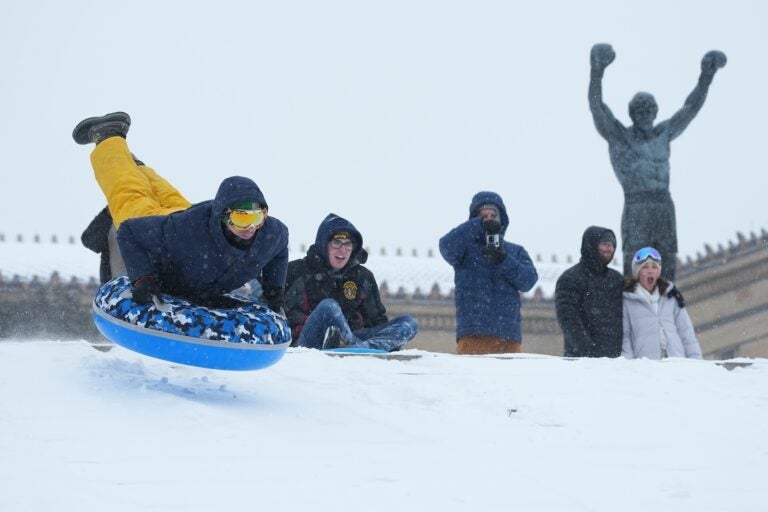 People sled on Philadelphia Art Museum steps by the Rocky statue during a winter storm in Philadelphia, Sunday, Jan. 25, 2026.