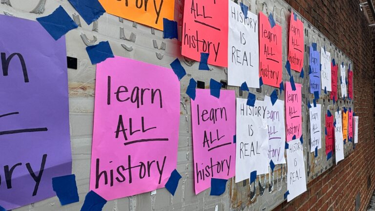 Handwritten signs reading 