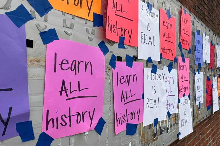 Handwritten signs reading 