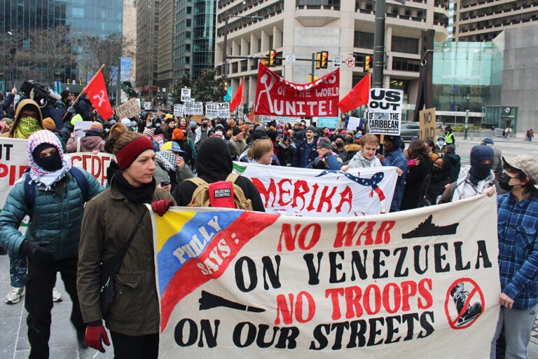 People hold up a sign that reads 