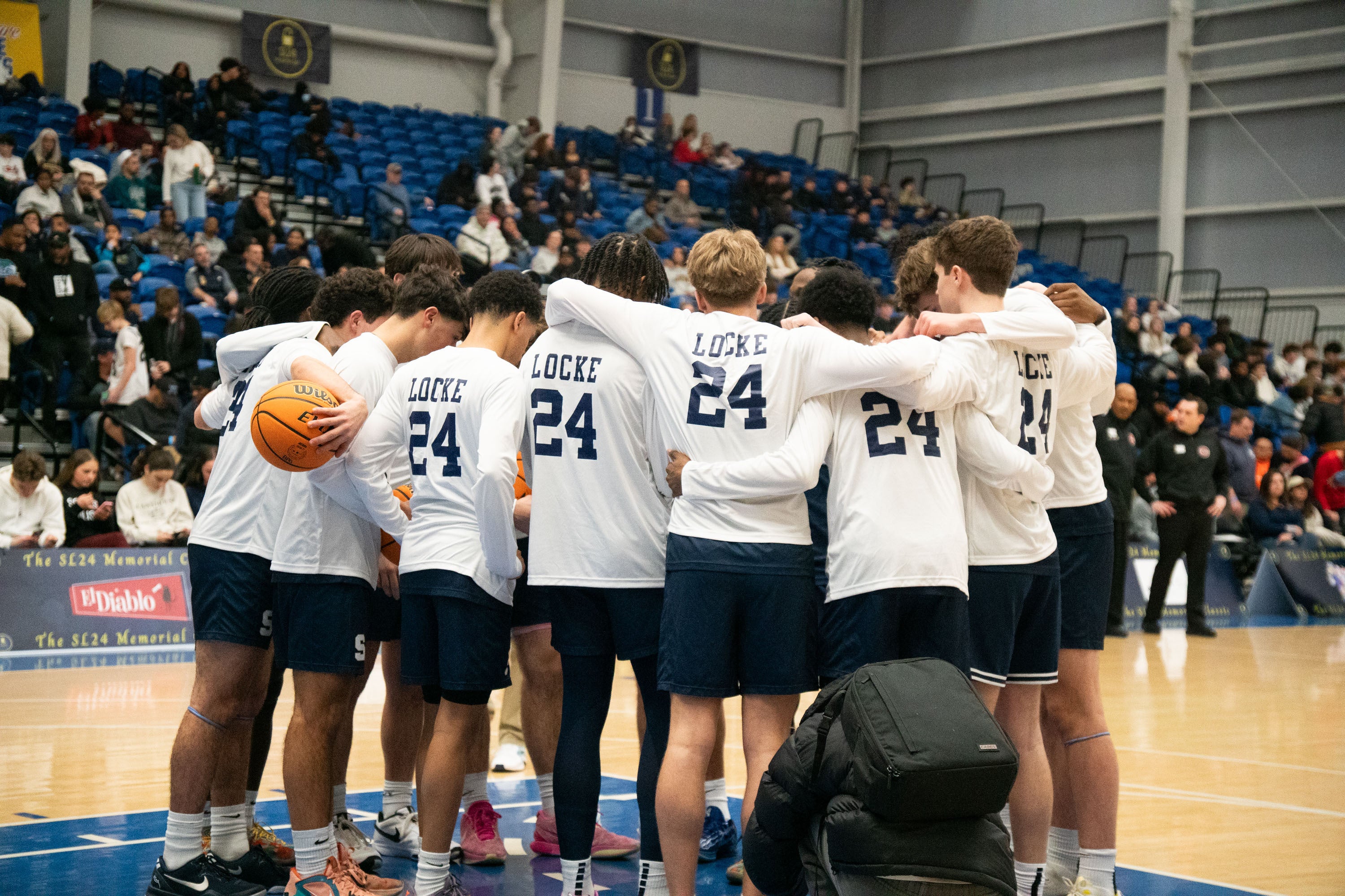A team huddles before tip-off during last year’s SL24 Basketball Classic