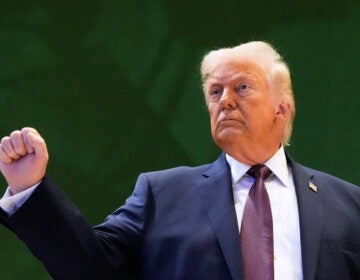 Switzerland Davos Trump US President Donald Trump holds up a fist