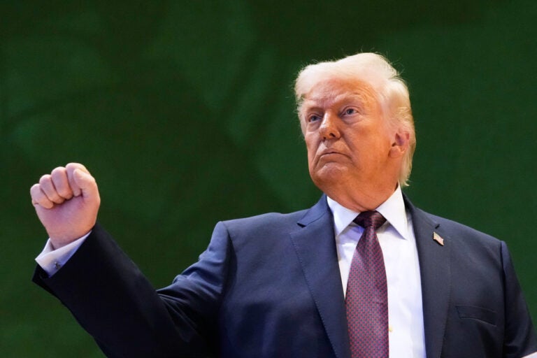 US President Donald Trump holds up a fist