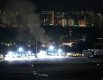 APTOPIX Venezuela US Smoke raises at La Carlota airport after explosions and low-flying aircraft were heard in Caracas, Venezuela