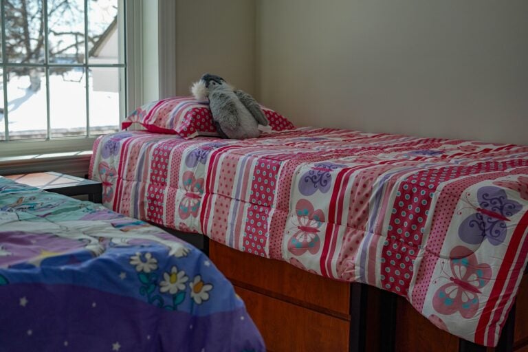 A room with 2 beds by the window in the shelter.