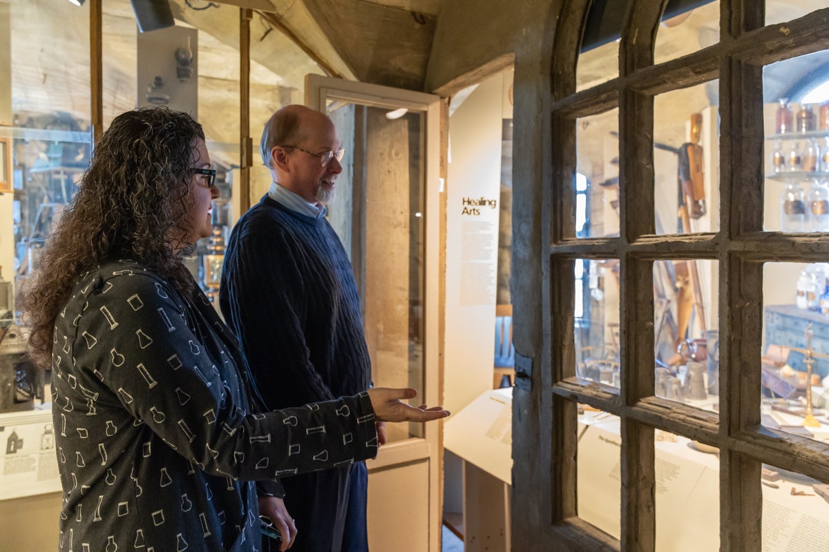 Anna Dhody and Cory Amsler look at artifacts