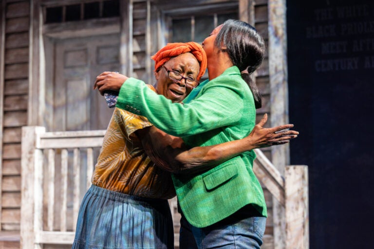 Lenny Daniels (left) hugs DeAnna Supplee embrace during Plantation Black