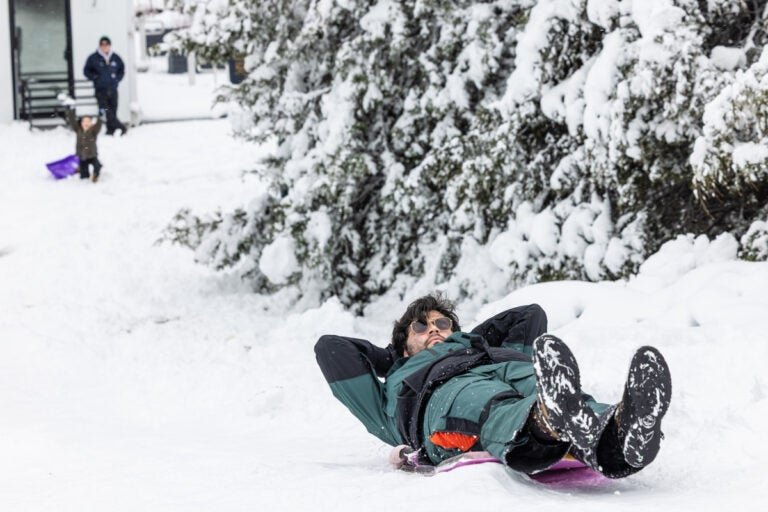 A man sledding down a hill at the Philadelphia Art Museum after the massive snowstorm