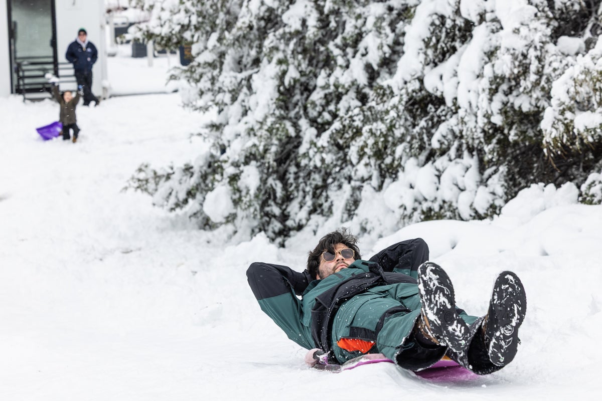A man sledding down a hill at the Philadelphia Art Museum after the massive snowstorm
