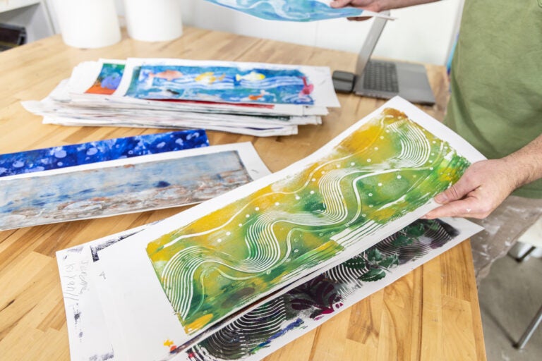 Ben Volta holding student artwork