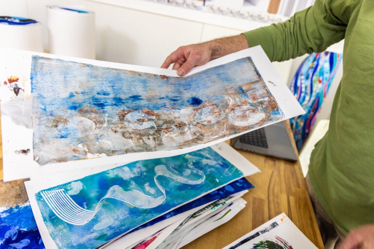 Ben Volta holding student artwork