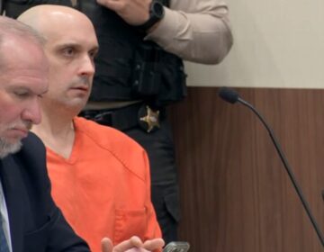 Sean Higgins, who is accused of killing hockey star Johnny Gaudreau and his brother Matthew, sits in an orange jumpsuit in court