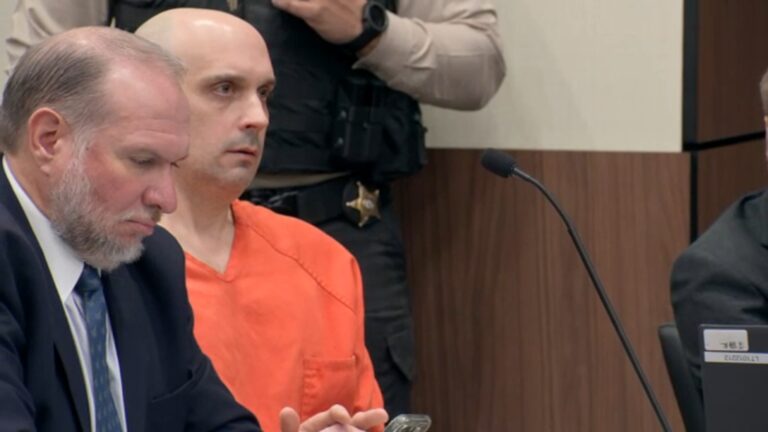 Sean Higgins, who is accused of killing hockey star Johnny Gaudreau and his brother Matthew, sits in an orange jumpsuit in court