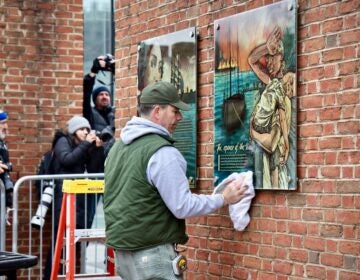 2025 02 19-e lee-philadelphia independence mall presidents house-slavery exhibit restored clean A National Park Service employee restores a panel to the slavery exhibit at the President's House site on Independence Mall.