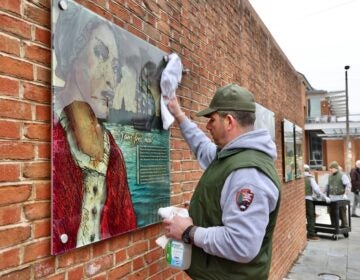 Workers are hanging the panels back up on the wall