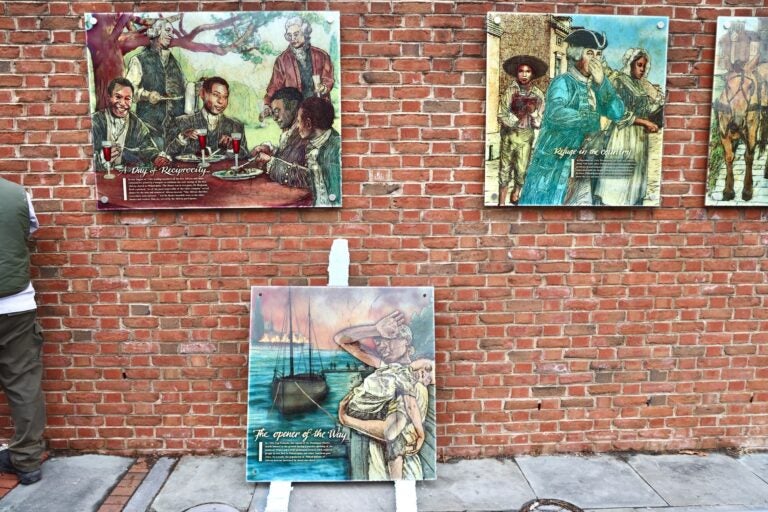 A panel rests on the floor, waiting to be hung back up. Several others are already back on the wall