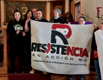 2026 02 27-e lee-trenton nj st bartholomew lutheran church-immigration detentions resistencia en accion People holding up a large banner that says Resistencia En Acción NJ