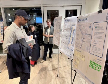Walt Walker, an environmental engineer who lives in West Philly, checks out posters at an open house on the future of the city's intercity bus station