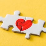 Puzzle pieces symbolizing connection being manipulated by unseen forces.