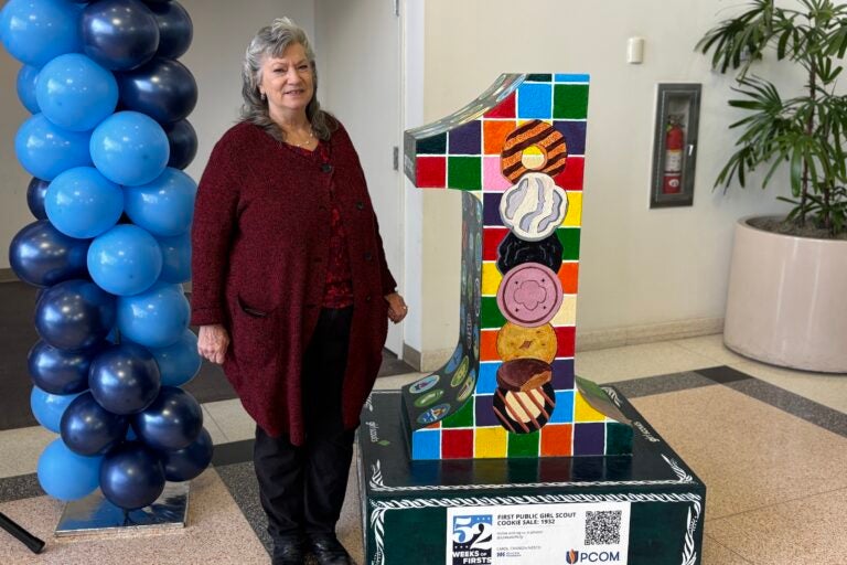 Carol Cannon-Nesco poses with the decorated Number 1 statue