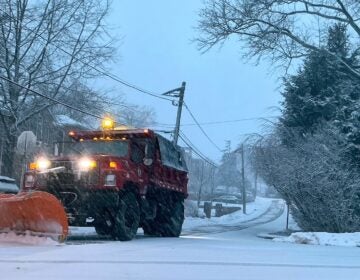 A plow starts removing snow from a residential street during the beginning of an intense winter storm, Sunday, Feb. 22, 2026, in Fort Lee, N.J.