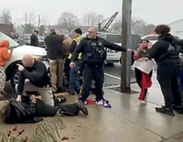 ice-protest-quakertown-police-student-arrests-022426 In a video screengrab, Quakertown police officers are seen arresting someone outside Sunday’s Deli & Restaurant, where students had gathered to protest ICE on Feb. 20, 2026.