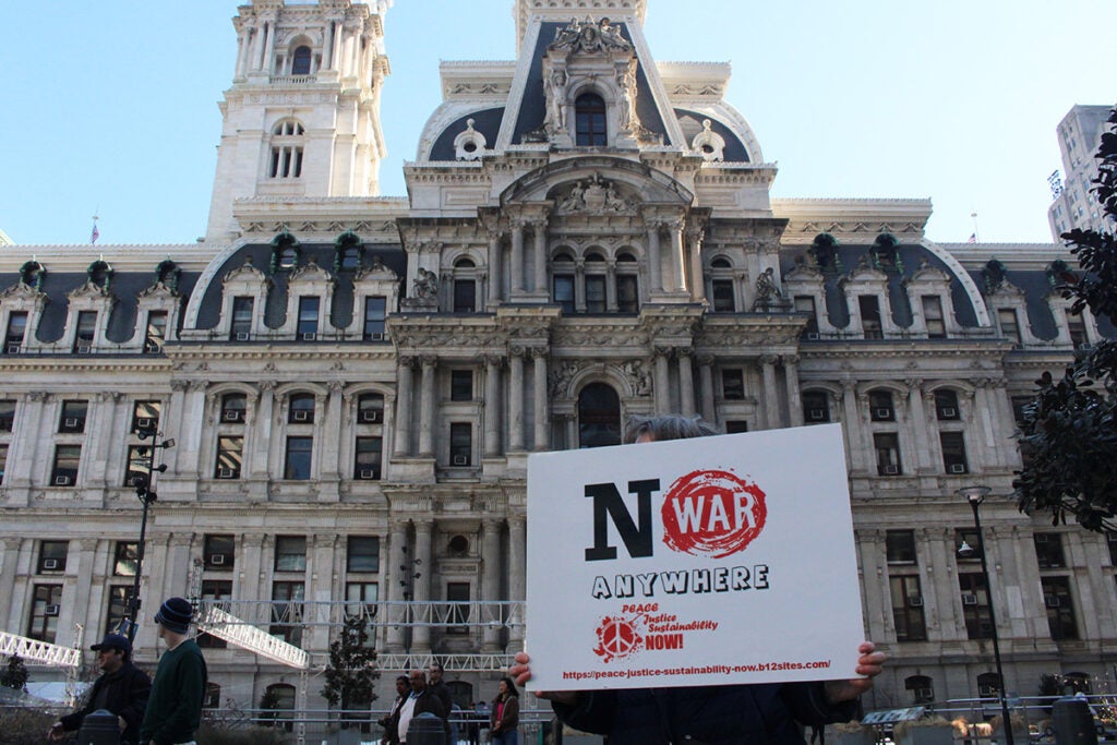 A person holds a sign that reads "No War Anywhere" in Philadelphia
