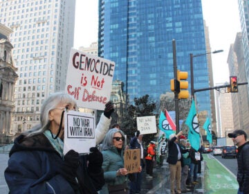 iran-war-protest-3 People hold signs in Philadelphia protesting war in Iran