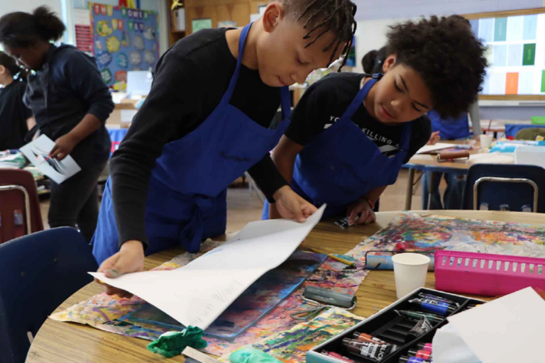 two students making art