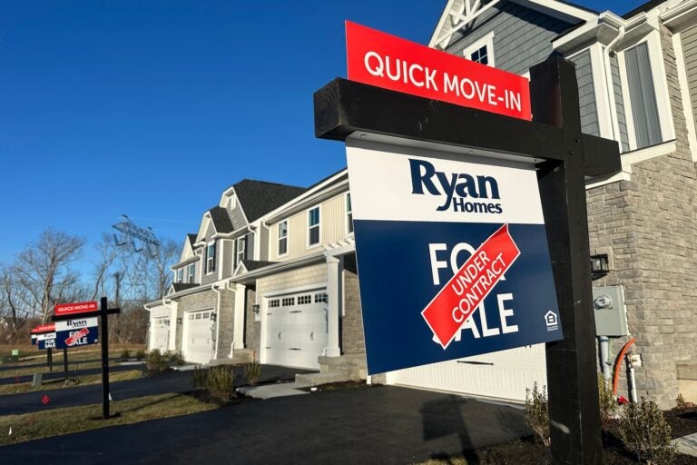 An ''under contract'' sign is seen atop a ''for sale'' sign outside a home in a residential development in Mount Olive, New Jersey