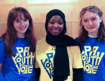 Three teenage girls posing for a photo in their PA YOUTH VOTE volunteer t-shirts