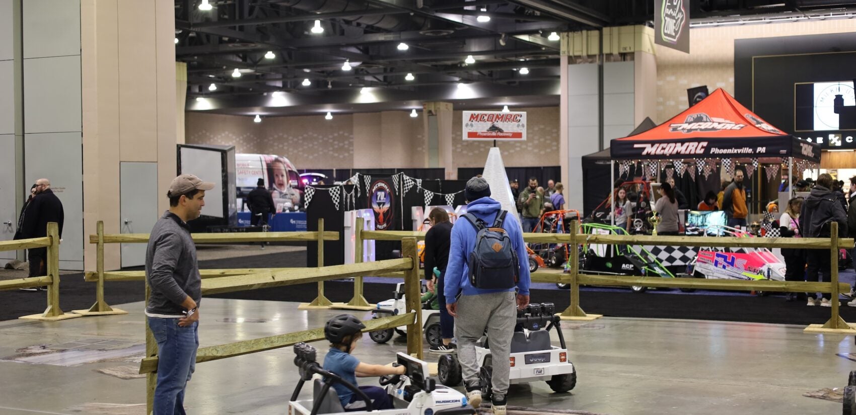 Kids test driving mini jeeps at the Auto Show
