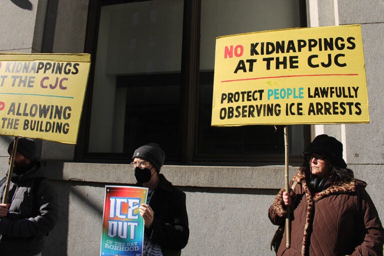 Protesters hold up handmade signs outside the Criminal Justice Center