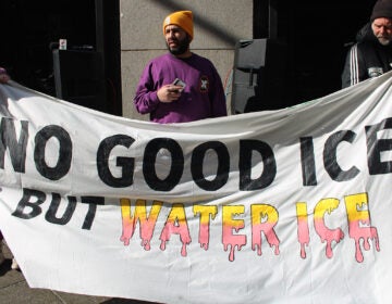 Protesters hold up handmade signs outside the Criminal Justice Center