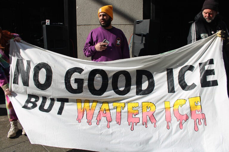 Protesters hold up handmade signs outside the Criminal Justice Center