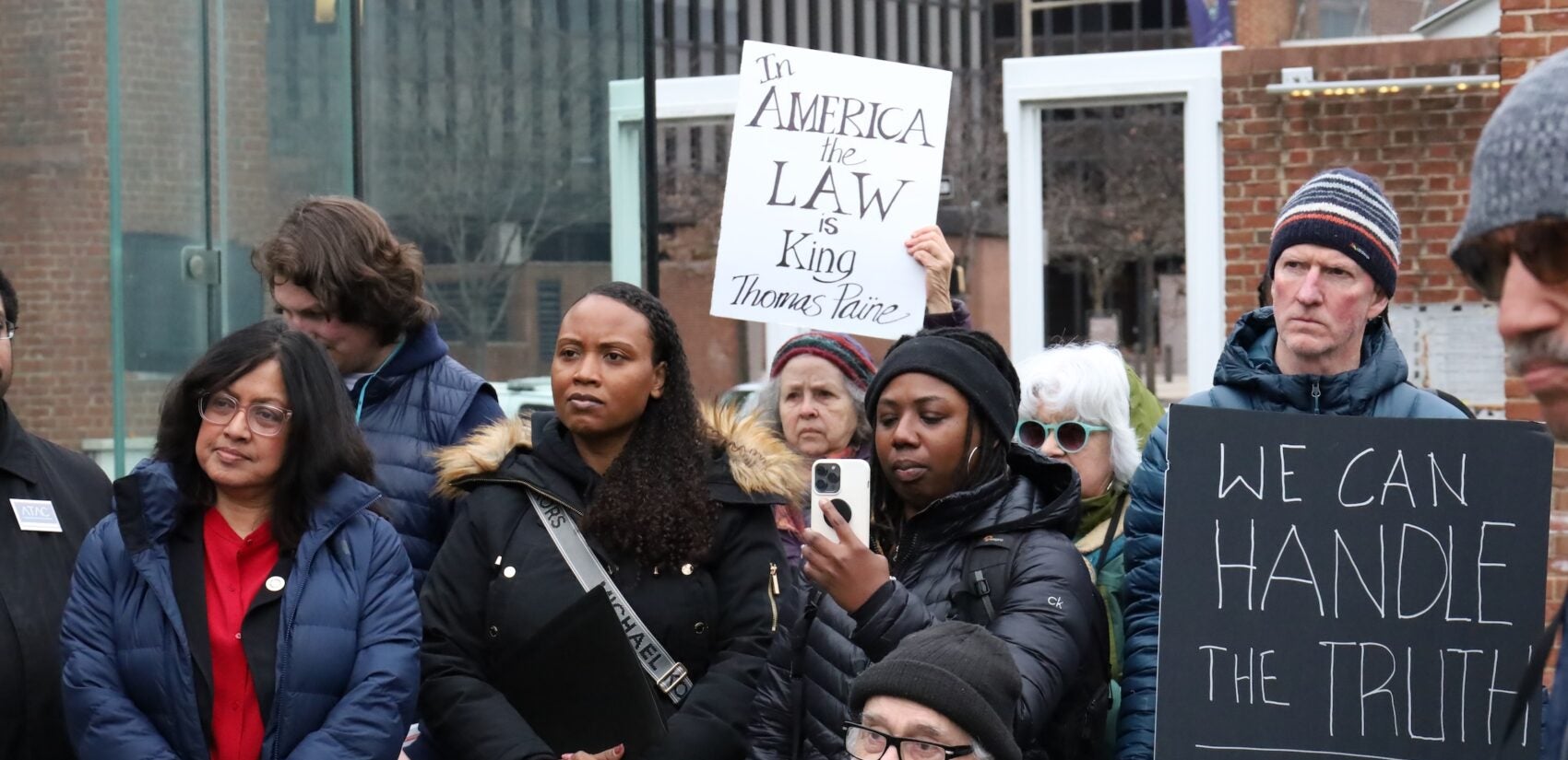 People holding up signs at the rally