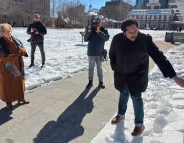 Cynthia Rufe and Mijuel Johnson look at the site of the slavery exhibit panels.