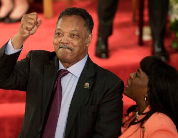 Rev. Jesse Jackson gestures to a friend in the balcony at the 16th Street Baptist Church in Birmingham, Ala., Sept. 15, 2013