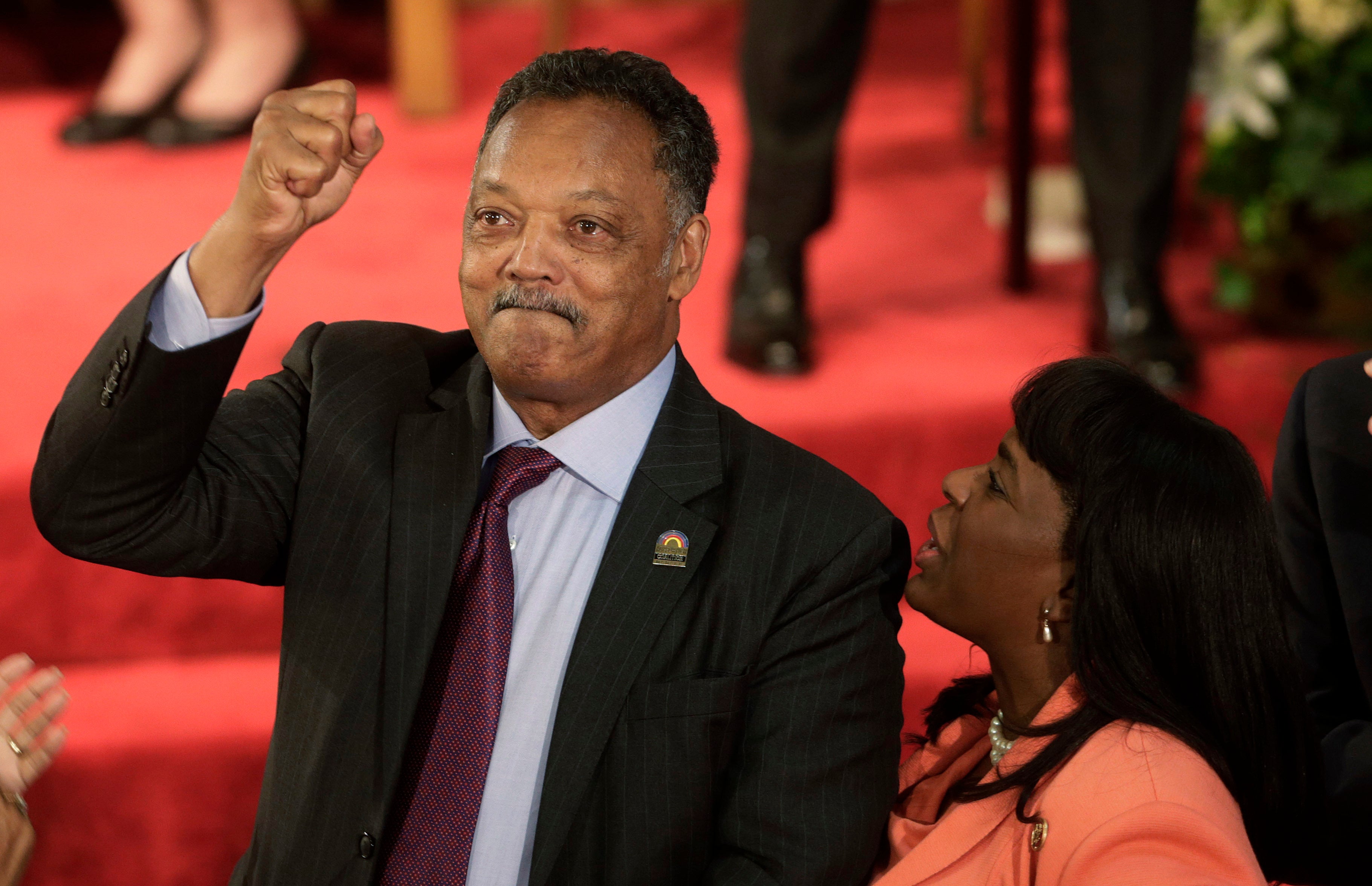 Rev. Jesse Jackson gestures to a friend in the balcony at the 16th Street Baptist Church in Birmingham, Ala., Sept. 15, 2013. (AP Photo/Dave Martin, File)